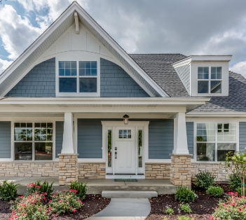 a house with bushes in front of a building